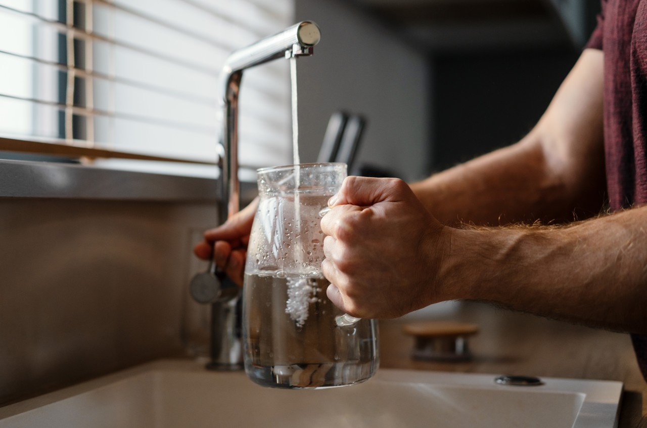 A man pouring water in the jug